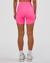 Woman wearing Fusion V-Contour Ultra High-Rise 6" Short Pockets - Sugar Plum | Model:Brylee | Size:XS