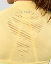 Woman wearing GG AeroFLX+ Long Sleeve Half Zip - Lemon-Baltic Sea | Model:Grace | Size:XS