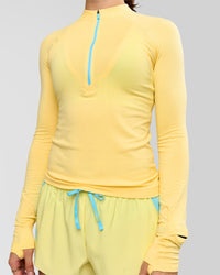 Woman wearing GG AeroFLX+ Long Sleeve Half Zip - Lemon-Baltic Sea | Model:Grace | Size:XS
