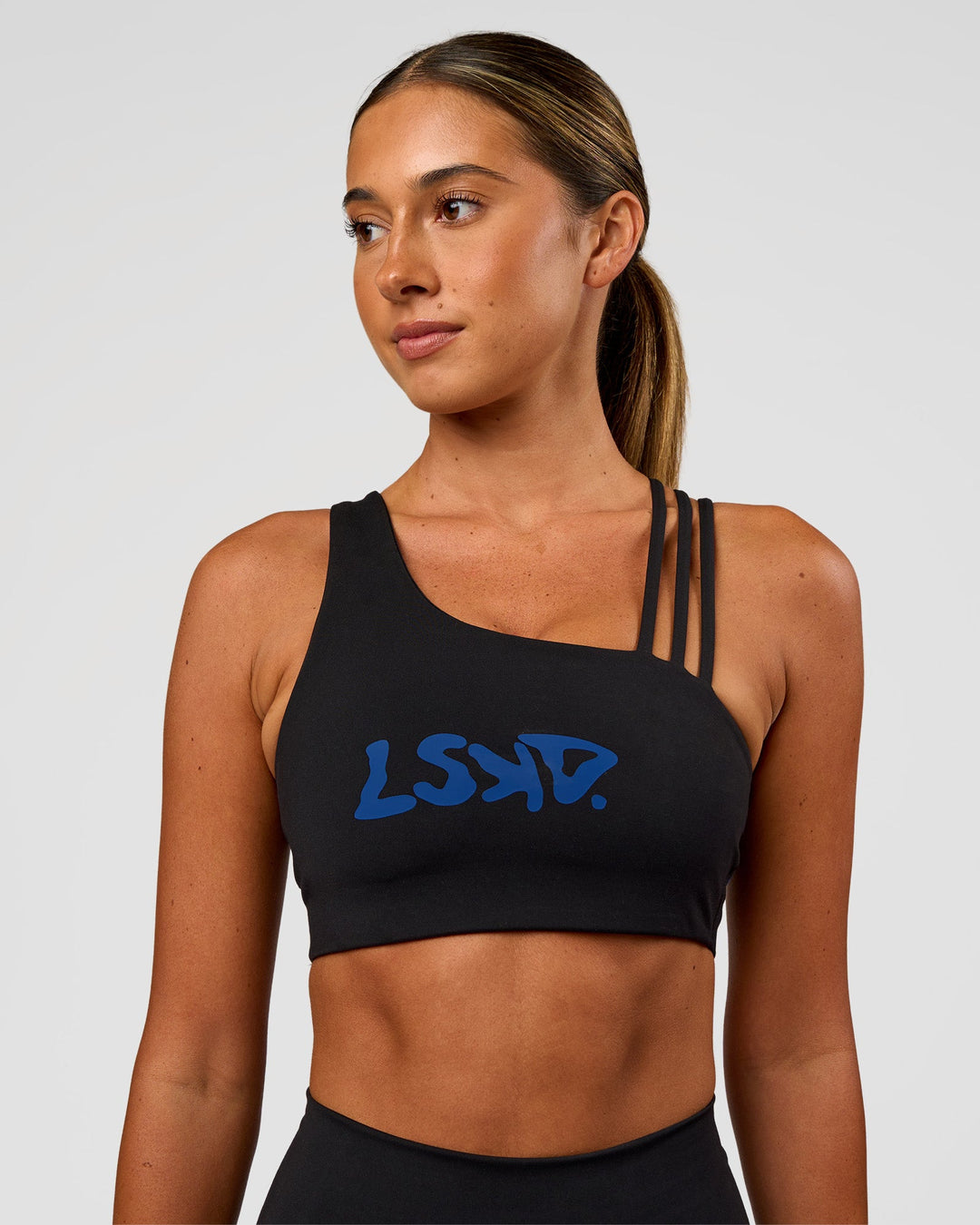 Woman wearing Galvanise Hype Graphic Sports Bra 2.0 - Black-Electric Indigo | Model:Charli | Size:XS