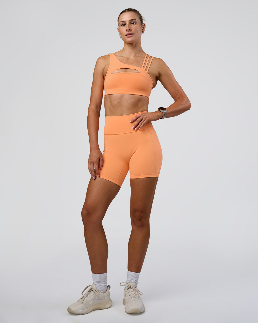 Woman wearing Galvanise Splice Sports Bra - Cantaloupe | Model:Emelia | Size:XS