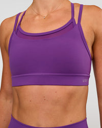 Woman wearing Genesis Layered Sports Bra - Fresh Purple | Model:Emelia | Size:XS