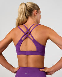 Woman wearing Genesis Layered Sports Bra - Fresh Purple | Model:Emelia | Size:XS
