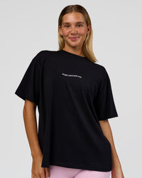 Woman wearing Go-To 1% Better Every Day FLXCotton Oversized Tee - Black-White | Model:Amity | Size:XS | Thumbnail Index: 0