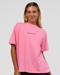 Woman wearing Go-To 1% Better Every Day FLXCotton Oversized Tee - Candy Pink-Black | Model:Amity | Size:XS | Thumbnail Index: 0
