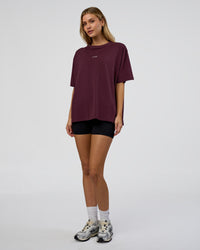 Woman wearing Go-To FLXCotton Oversized Tee - Cherry Lacquer-White | Model:Leilani | Size:XS