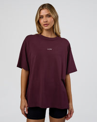 Woman wearing Go-To FLXCotton Oversized Tee - Cherry Lacquer-White | Model:Leilani | Size:XS | Thumbnail Index: 0