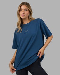 Woman wearing Go-To FLXCotton Oversized Tee - Indigo-White | Model:Leilani | Size:XS