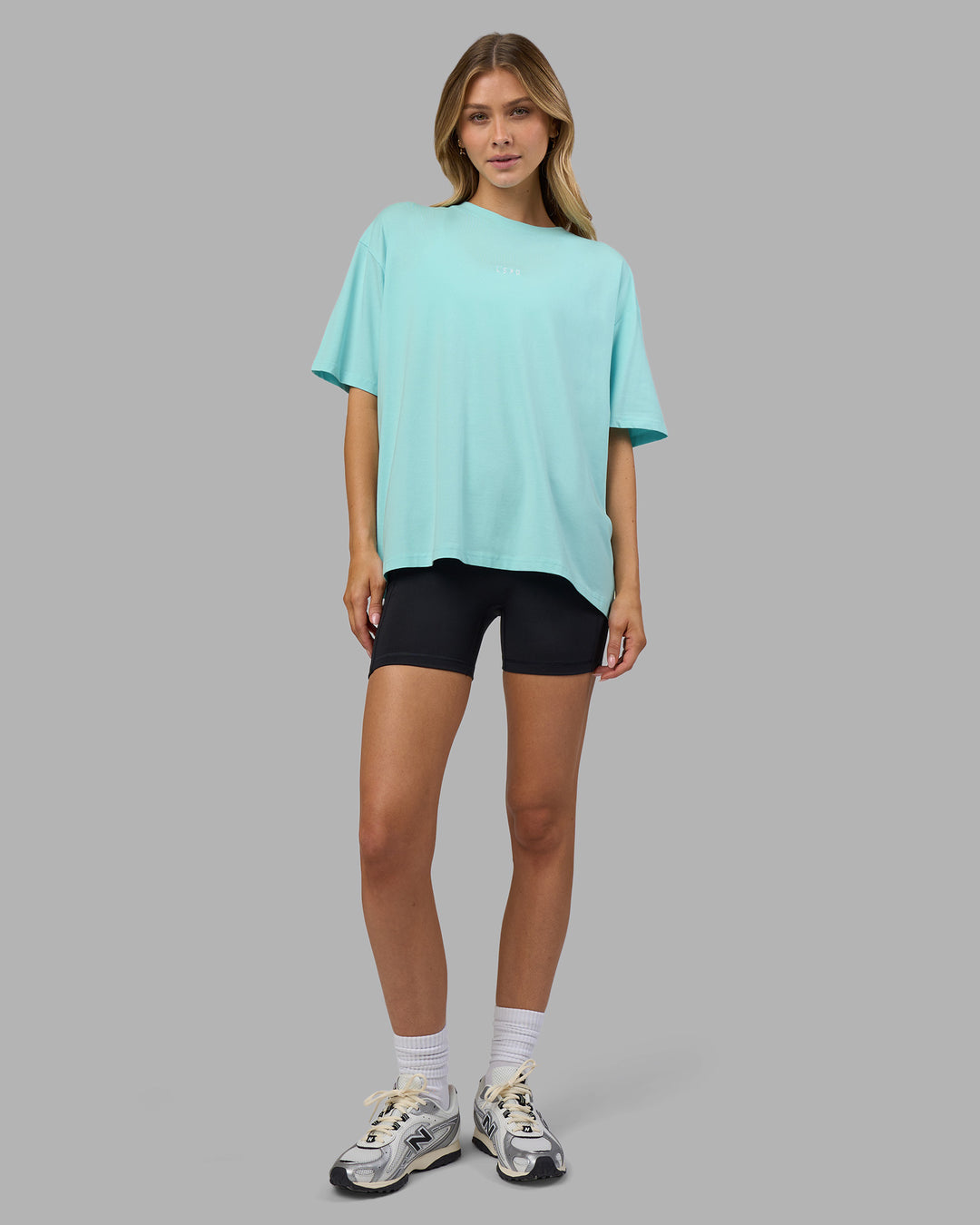 Woman wearing Go-To FLXCotton Oversized Tee - Island Paradise-White | Model:Leilani | Size:XS