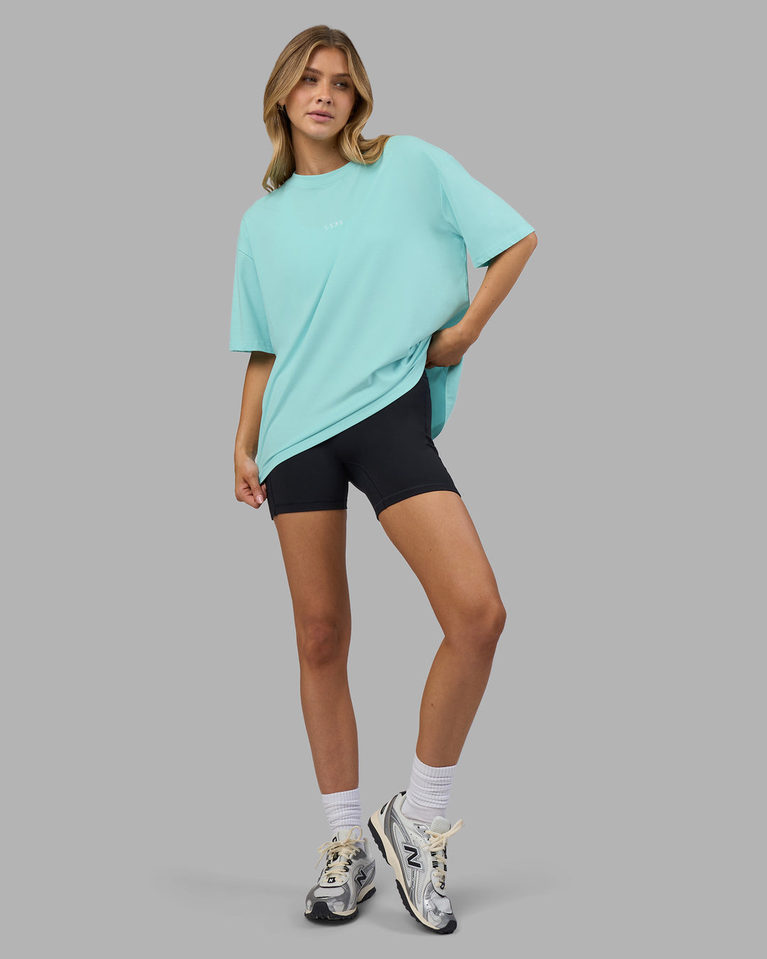 Woman wearing Go-To FLXCotton Oversized Tee - Island Paradise-White | Model:Leilani | Size:XS