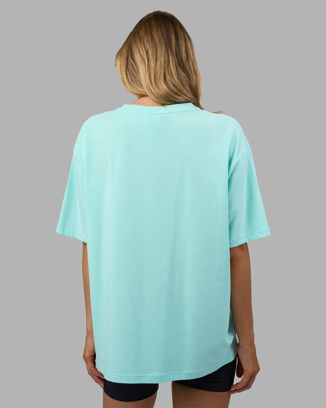 Woman wearing Go-To FLXCotton Oversized Tee - Island Paradise-White | Model:Leilani | Size:XS