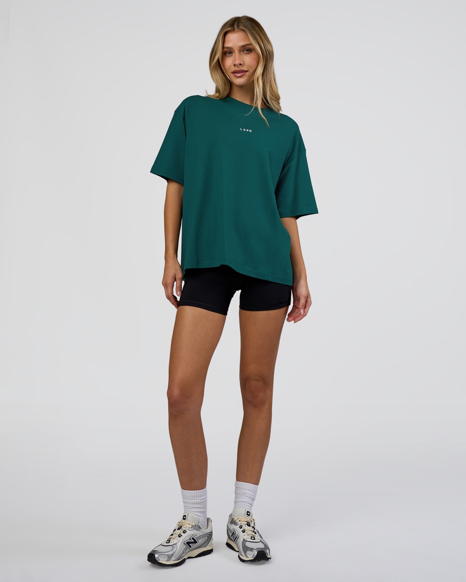 Woman wearing Go-To FLXCotton Oversized Tee - Transformative Teal-White | Model:Leilani | Size:XS