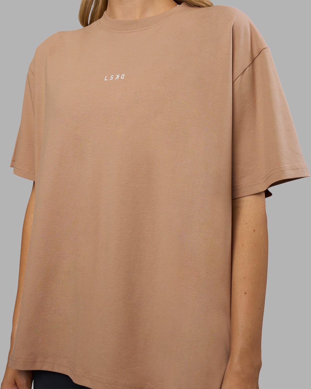 Woman wearing Go-To FLXCotton Oversized Tee - Warm Smoke-White | Model:Leilani | Size:XS