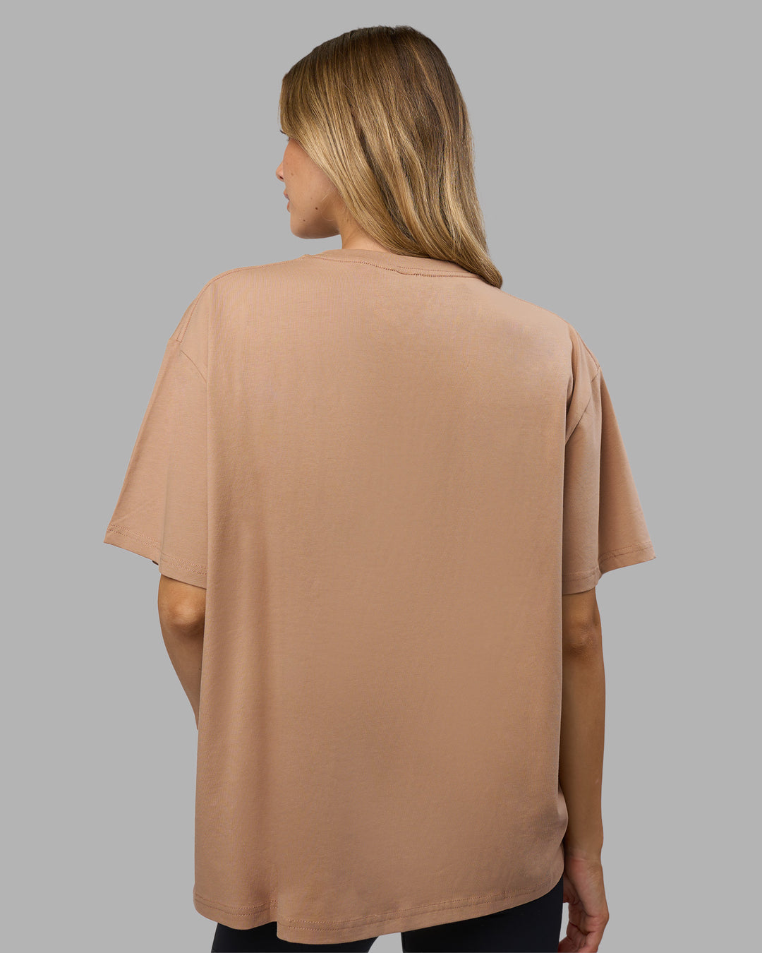 Woman wearing Go-To FLXCotton Oversized Tee - Warm Smoke-White | Model:Leilani | Size:XS