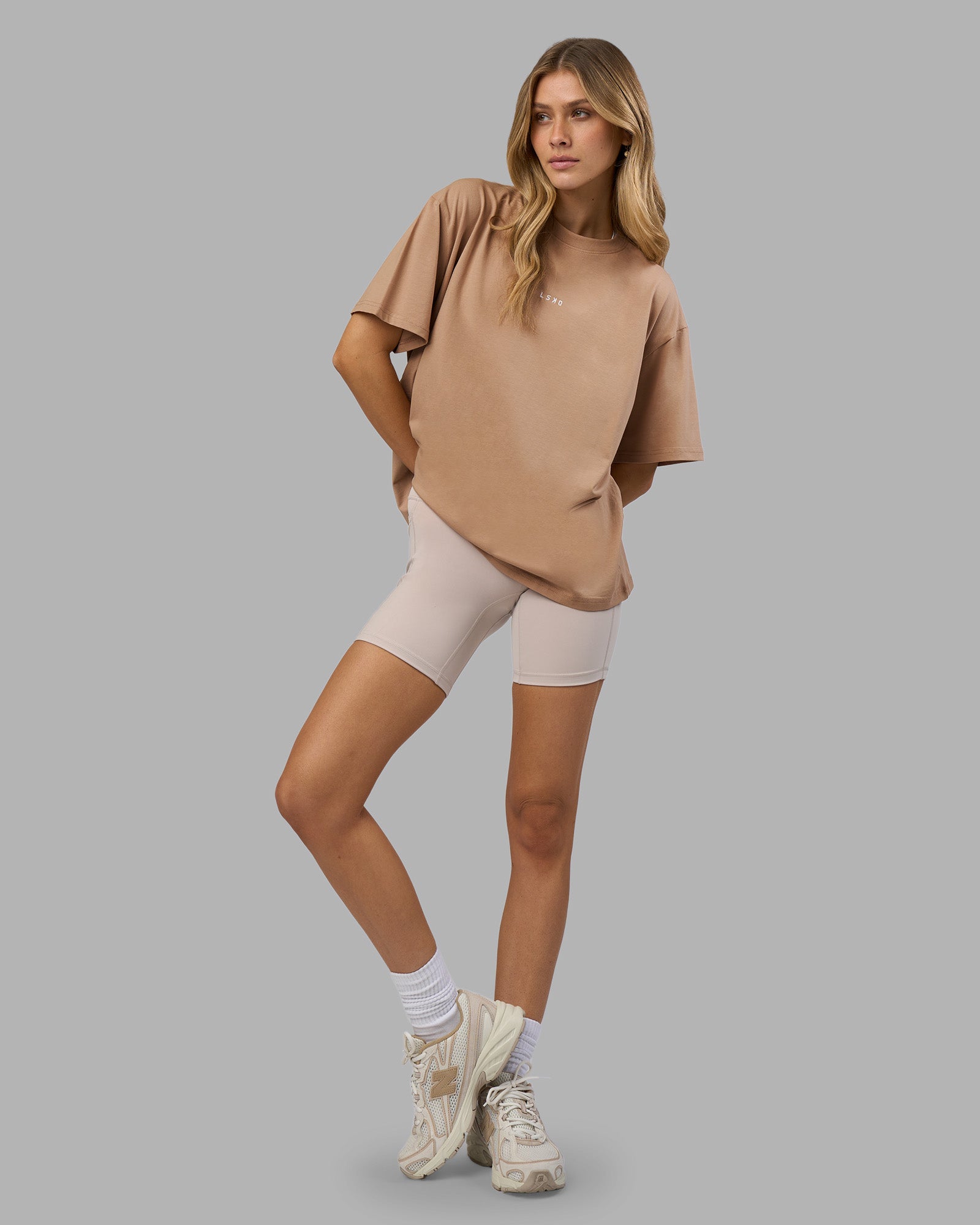 Woman wearing Go-To FLXCotton Oversized Tee - Warm Smoke-White | Model:Leilani | Size:XS