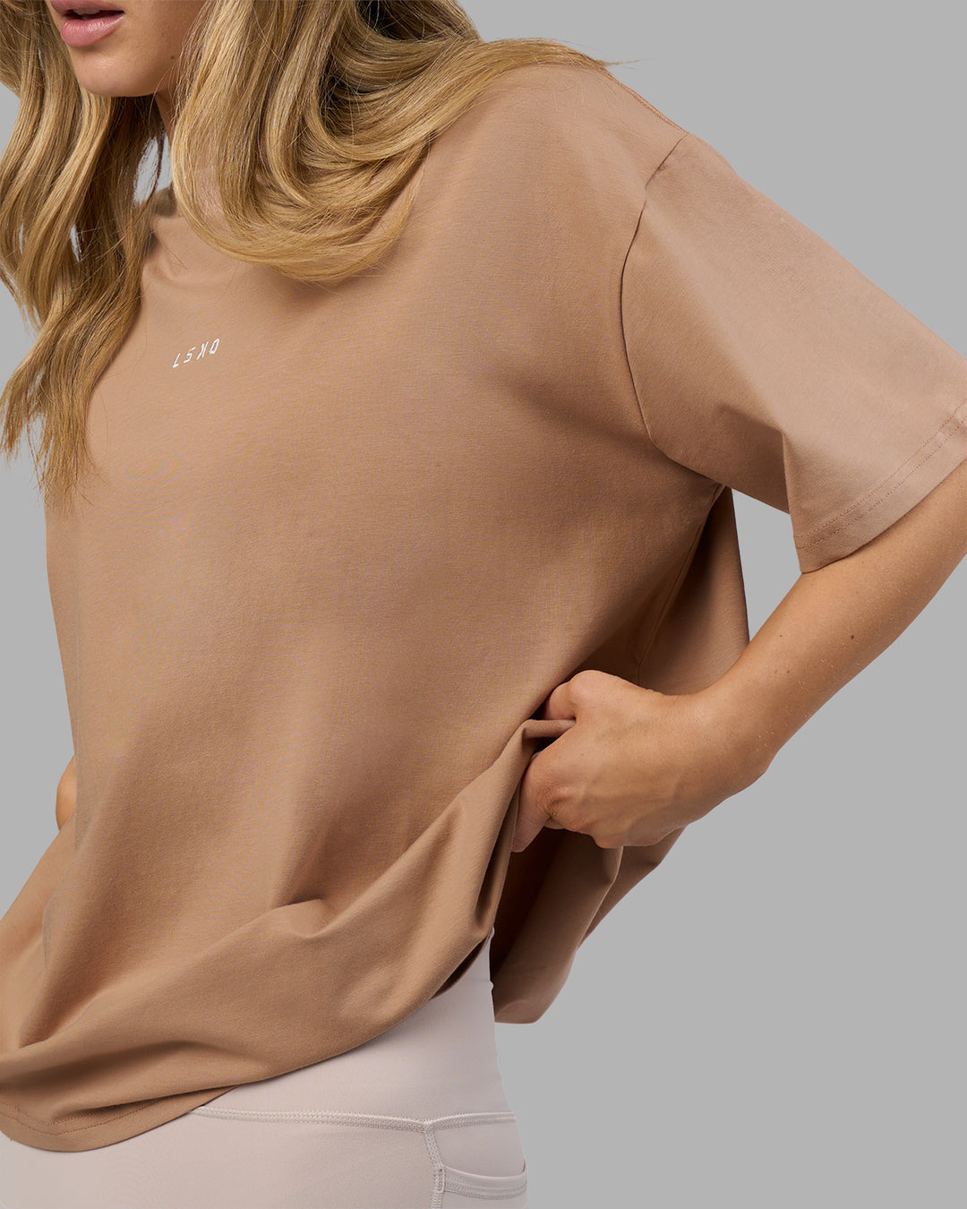 Woman wearing Go-To FLXCotton Oversized Tee - Warm Smoke-White | Model:Leilani | Size:XS