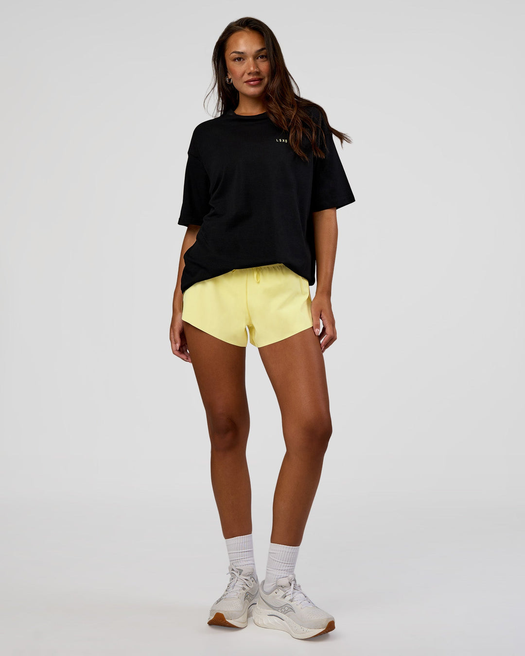 Woman wearing High Run FLXCotton Oversized Tee - Black-Yellow Fizz | Model:Kirstyn | Size:XS