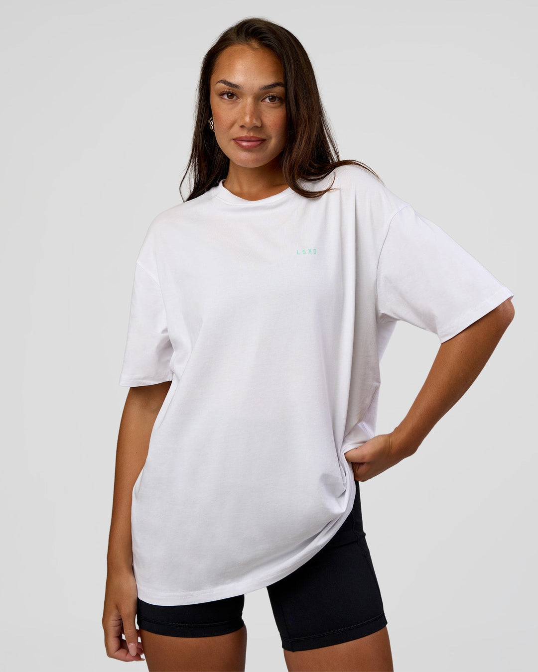 Woman wearing High Run FLXCotton Oversized Tee - White-Jelly Mint | Model:Kirstyn | Size:XS