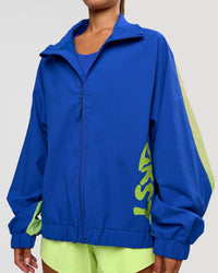 Woman wearing Hype Oversized Track Jacket - Electric Indigo | Model:Brylee | Size:XS | Thumbnail Index: 10