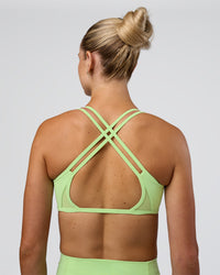 Woman wearing Interstellar Sports Bra - Solar Lime | Model:Emelia | Size:XS