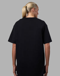 Woman wearing Just Keep Running FLXCotton Oversized Tee - Black | Model:Katie | Size:XS