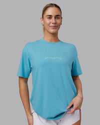 Woman wearing Just Run FLXCotton Oversized Tee - Retro Blue-Light Retro Blue | Model:Hannah | Size:XS