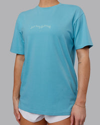 Woman wearing Just Run FLXCotton Oversized Tee - Retro Blue-Light Retro Blue | Model:Hannah | Size:XS