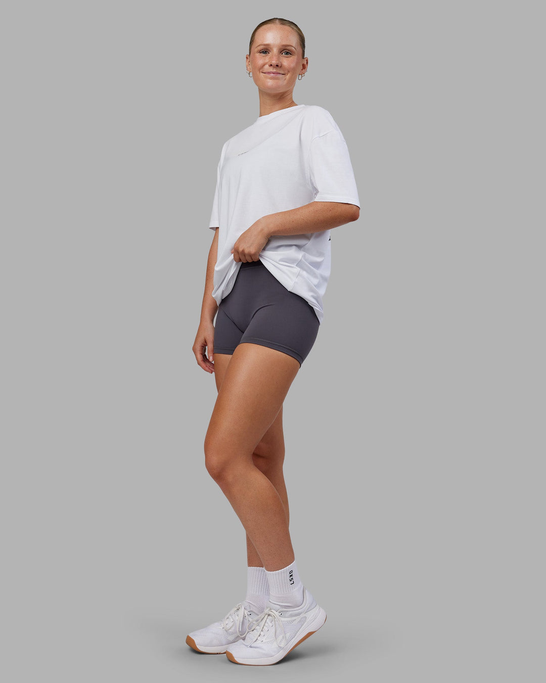 Woman wearing Kettlebell FLXCotton Oversized Tee - White-Black | Model:Neve | Size:XS
