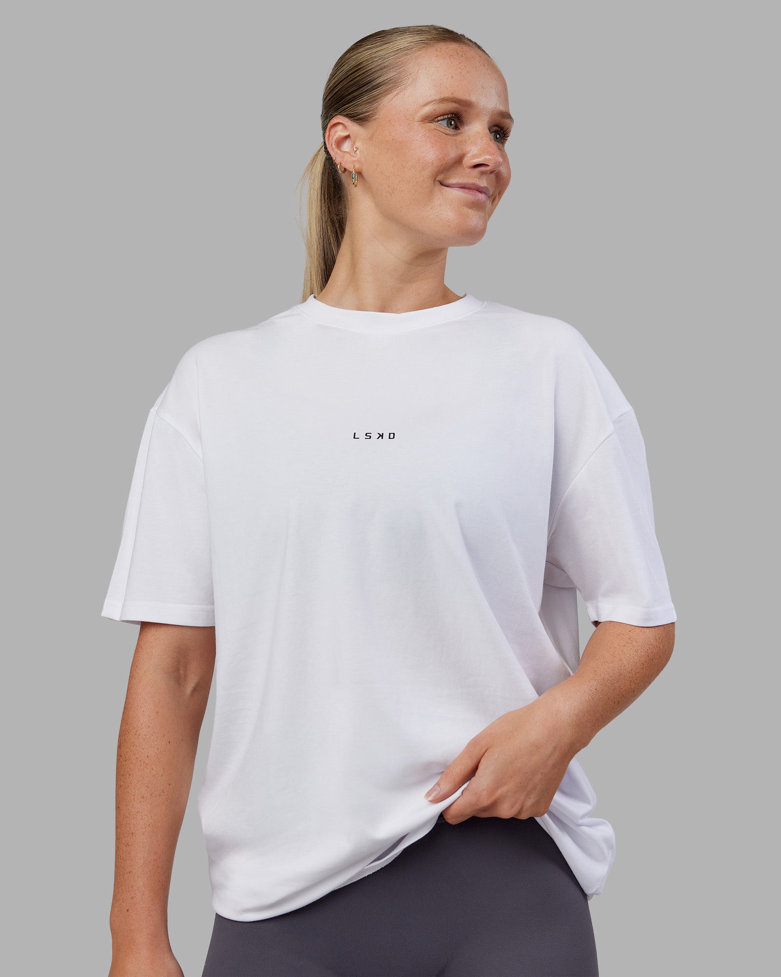 Woman wearing Kettlebell FLXCotton Oversized Tee - White-Black | Model:Neve | Size:XS