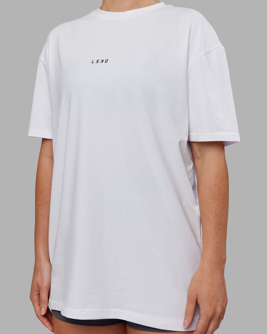 Woman wearing Kettlebell FLXCotton Oversized Tee - White-Black | Model:Neve | Size:XS
