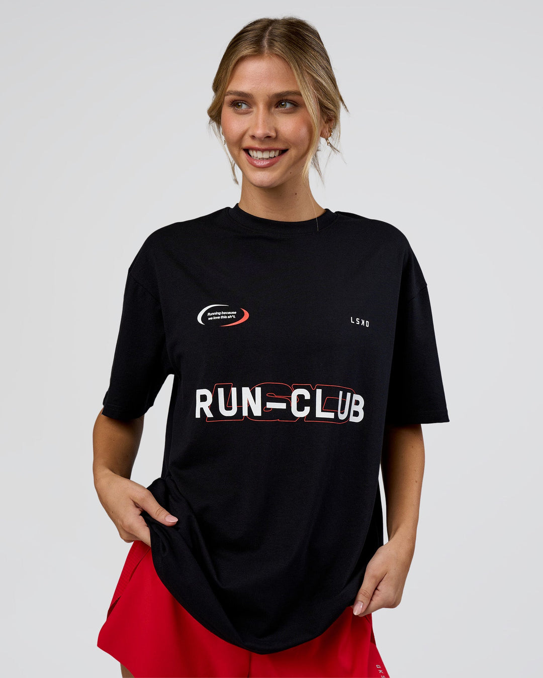 Woman wearing LSKD Run Club FLXCotton Oversized Tee - Black-White | Model:Leilani | Size:XS