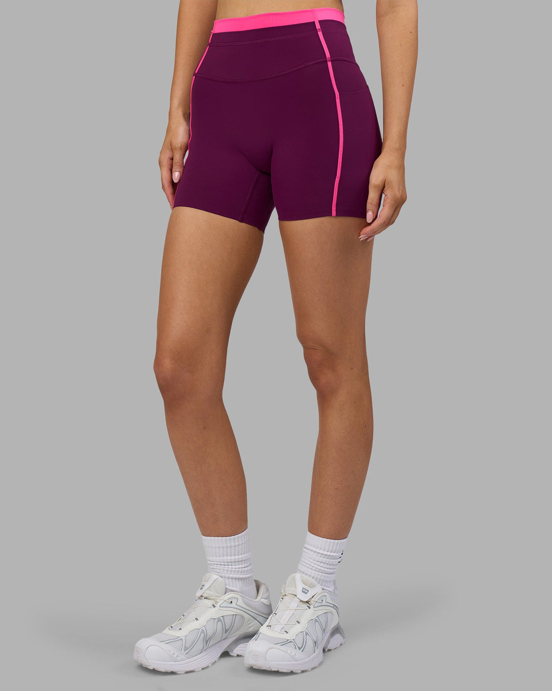 Woman wearing Liberate Contrast High-Rise 4&quot; Short Pockets - Plum Caspia-Ultra Pink | Model:Leilani | Size:XS