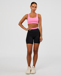 Woman wearing Liberate High-Rise 6" Short Pockets - Black-Candy Pink | Model:Brylee | Size:XS