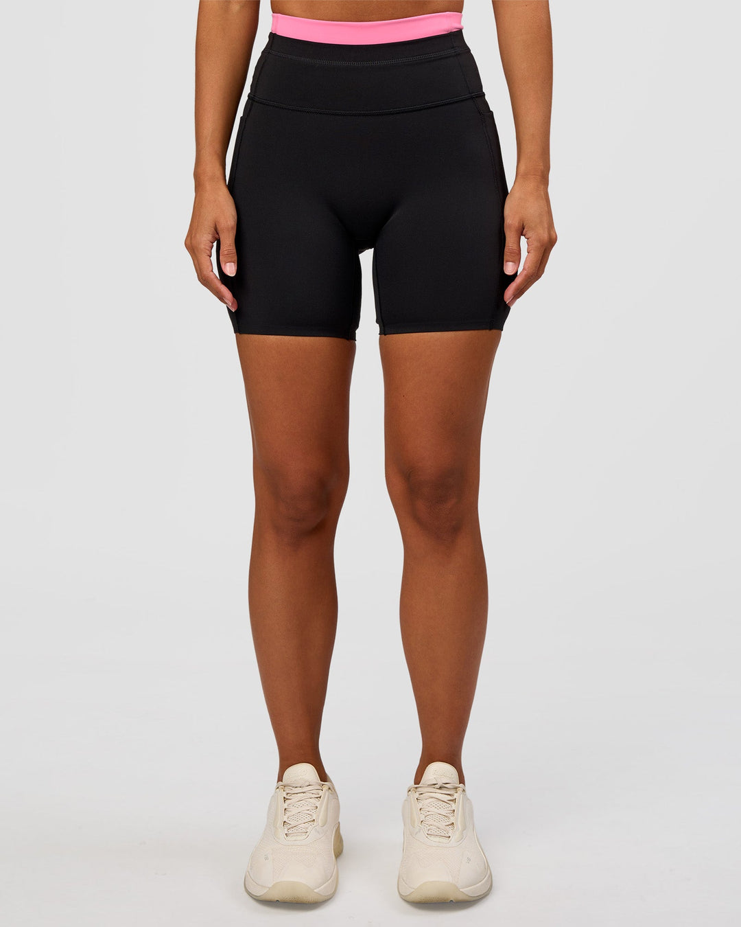 Woman wearing Liberate High-Rise 6" Short Pockets - Black-Candy Pink | Model:Brylee | Size:XS