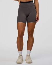 Woman wearing Liberate High-Rise 6" Short Pockets in Duskstone-Black | Model:Maja | Size:XS