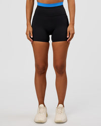 Woman wearing Liberate High-Rise 4" Short Pockets - Black-Palace Blue | Model:Brylee | Size:XS