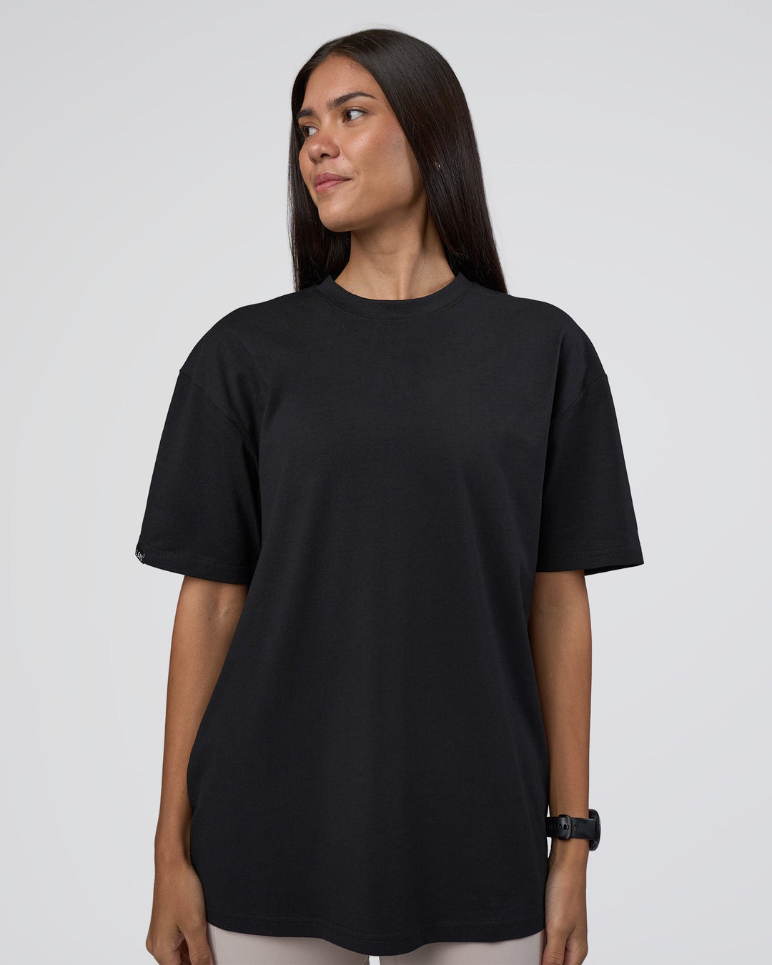 Woman wearing Lifting Club FLXCotton Tee Oversize - Black-Black | Model:Rhiley | Size:XS