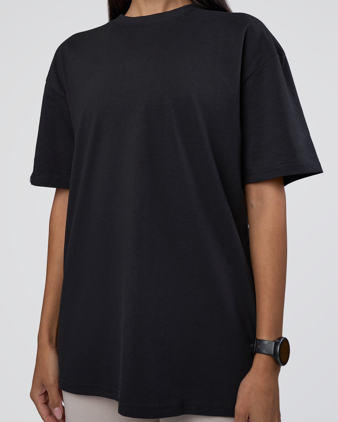 Woman wearing Lifting Club FLXCotton Tee Oversize - Black-Black | Model:Rhiley | Size:XS