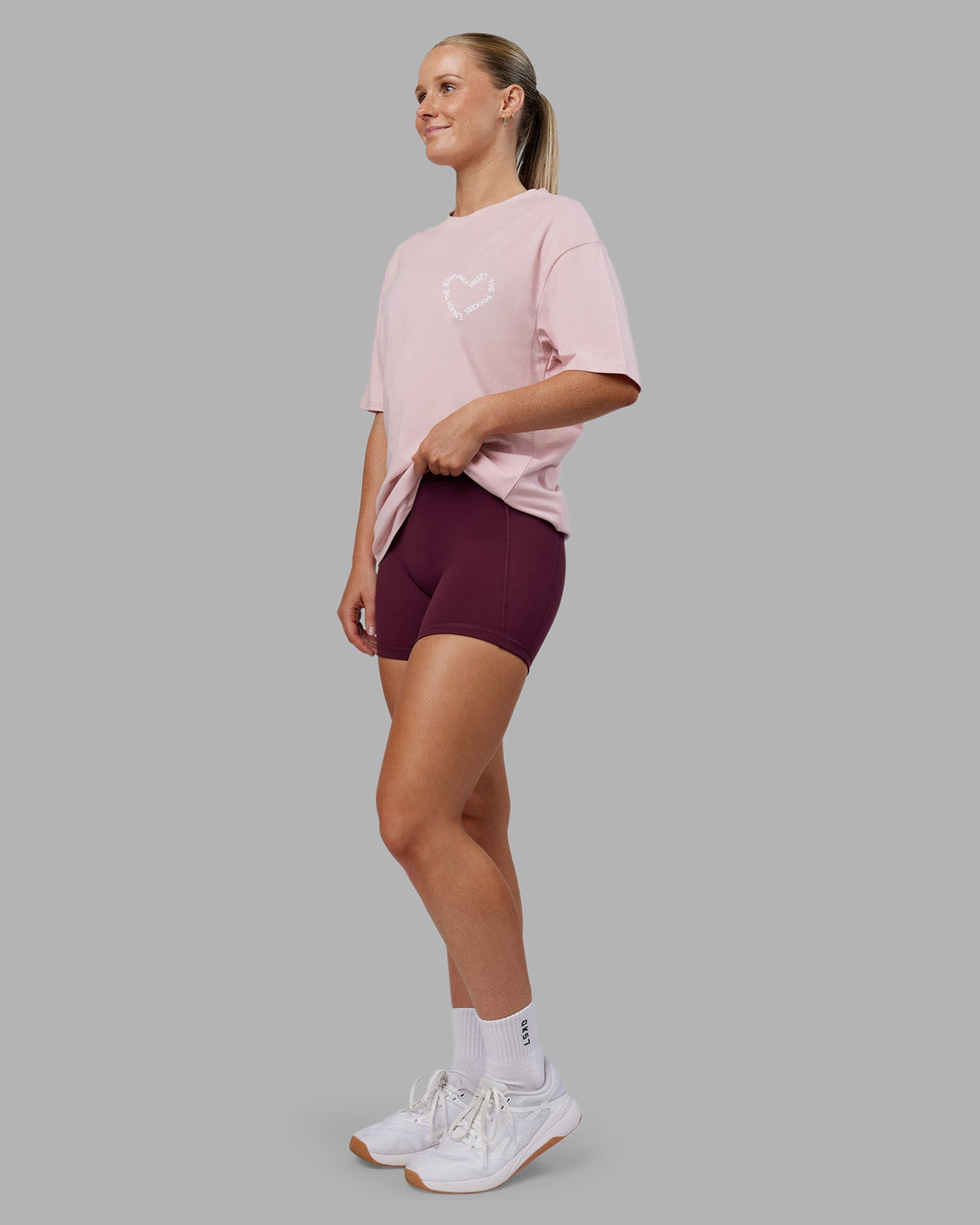 Woman wearing Love The Process FLXCotton Oversize Tee - Petal Pink-White | Model:Neve | Size:XS