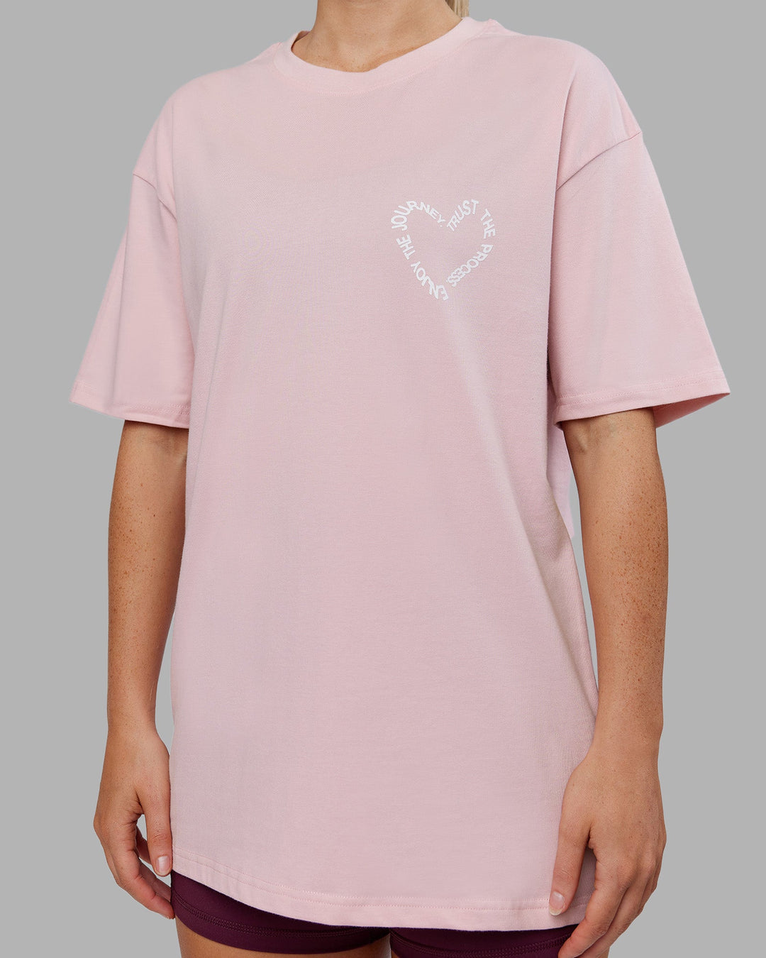 Woman wearing Love The Process FLXCotton Oversize Tee - Petal Pink-White | Model:Neve | Size:XS