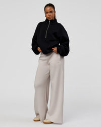 Woman wearing Luxe ZeroCrease Spacer Half Zip - Black | Model:Sophia | Size:XS