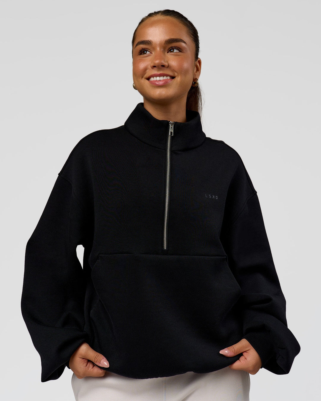 Woman wearing Luxe ZeroCrease Spacer Half Zip - Black | Model:Sophia | Size:XS