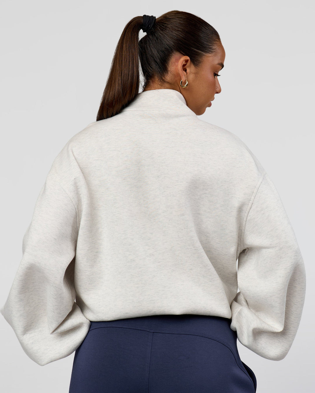Woman wearing Luxe ZeroCrease Spacer Half Zip - Silver Marl | Model:Sophia | Size:XS