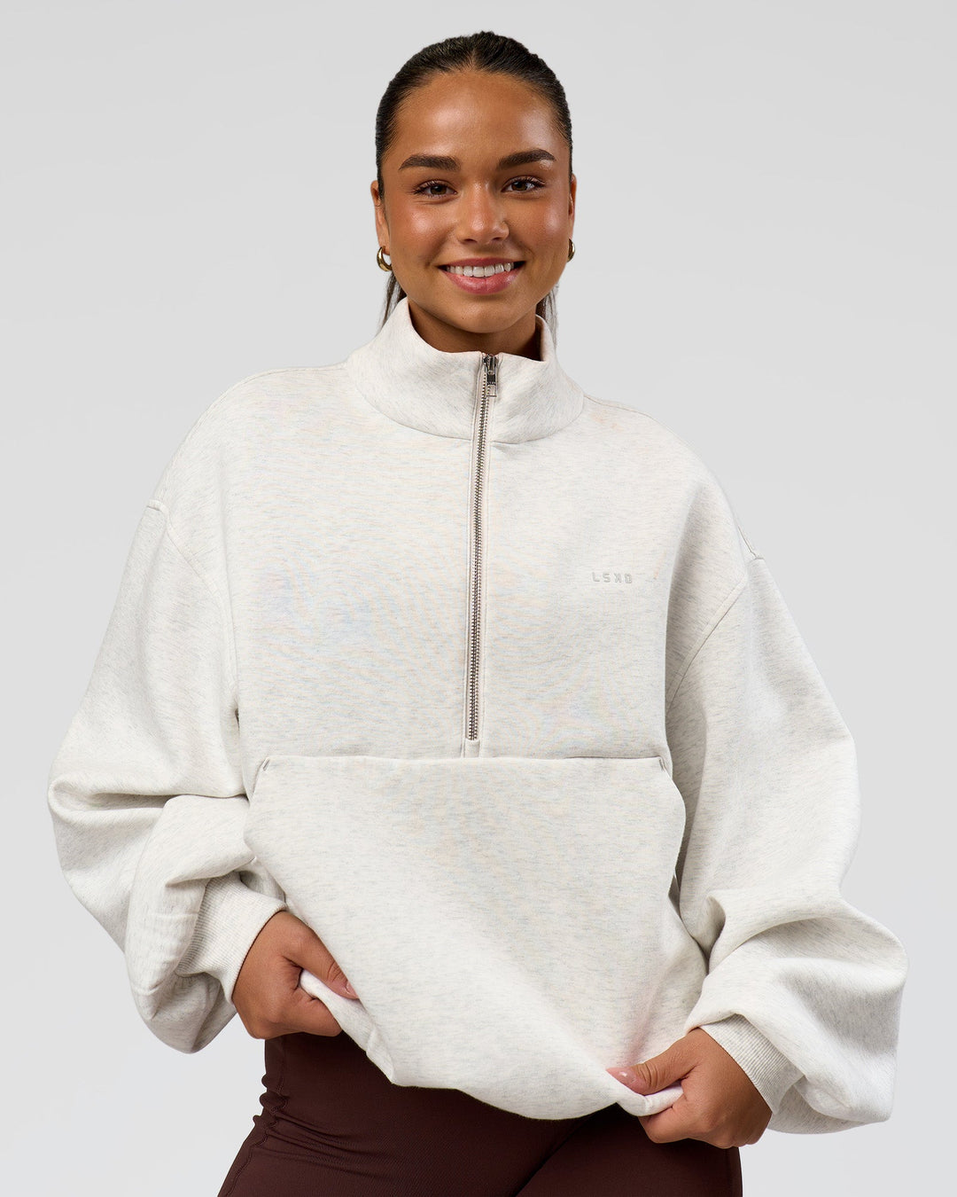Woman wearing Luxe ZeroCrease Spacer Half Zip - Silver Marl | Model:Sophia | Size:XS
