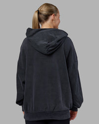 Woman wearing MVP Washed Terry Oversized Hoodie - Black Washed | Model:Neve | Size:XS