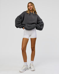 Woman wearing Memory In Motion Ultra Heavyweight Washed Hoodie - Dark Storm Washed | Model:Leilani | Size:XS