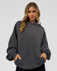 Woman wearing Memory In Motion Ultra Heavyweight Washed Hoodie - Dark Storm Washed | Model:Leilani | Size:XS