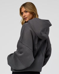 Woman wearing Memory In Motion Ultra Heavyweight Washed Hoodie - Dark Storm Washed | Model:Leilani | Size:XS