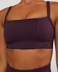 Woman wearing Momentum Corset Sports Bra - Midnight Plum | Model:Brylee | Size:XS
