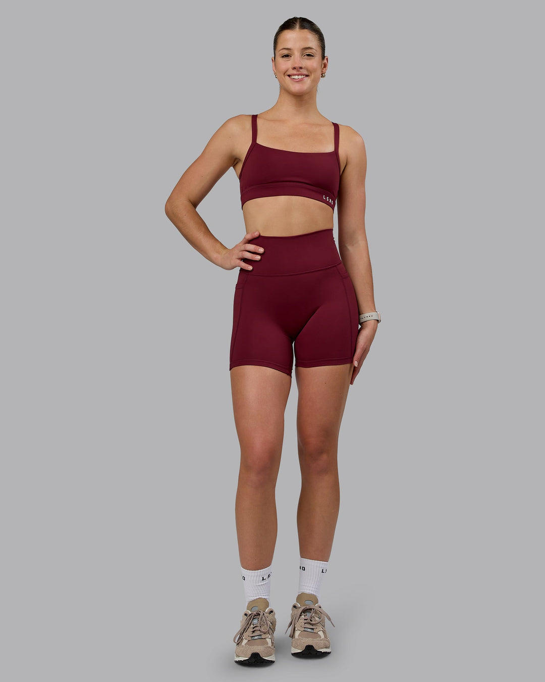 Woman wearing Momentum Sports Bra - Cordovan